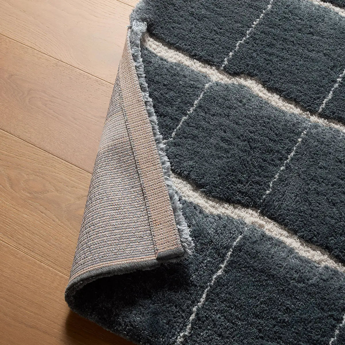 Gray checkered rug on a wooden floor