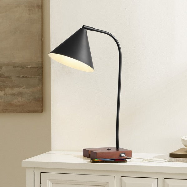 Modern black table lamp on a wooden surface with a neutral background