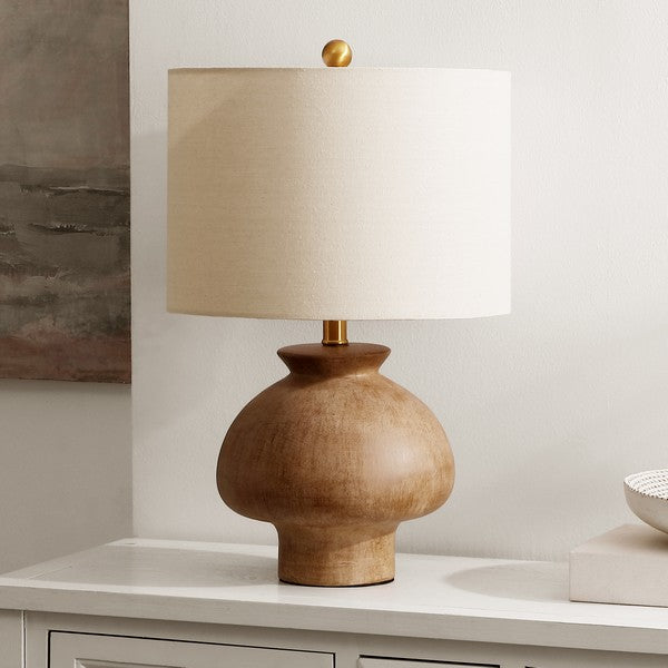 A ceramic table lamp with a light brown finish and a beige fabric shade.