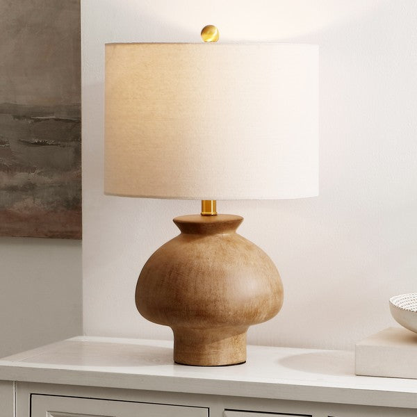 A ceramic table lamp with a light brown finish and a beige fabric shade.