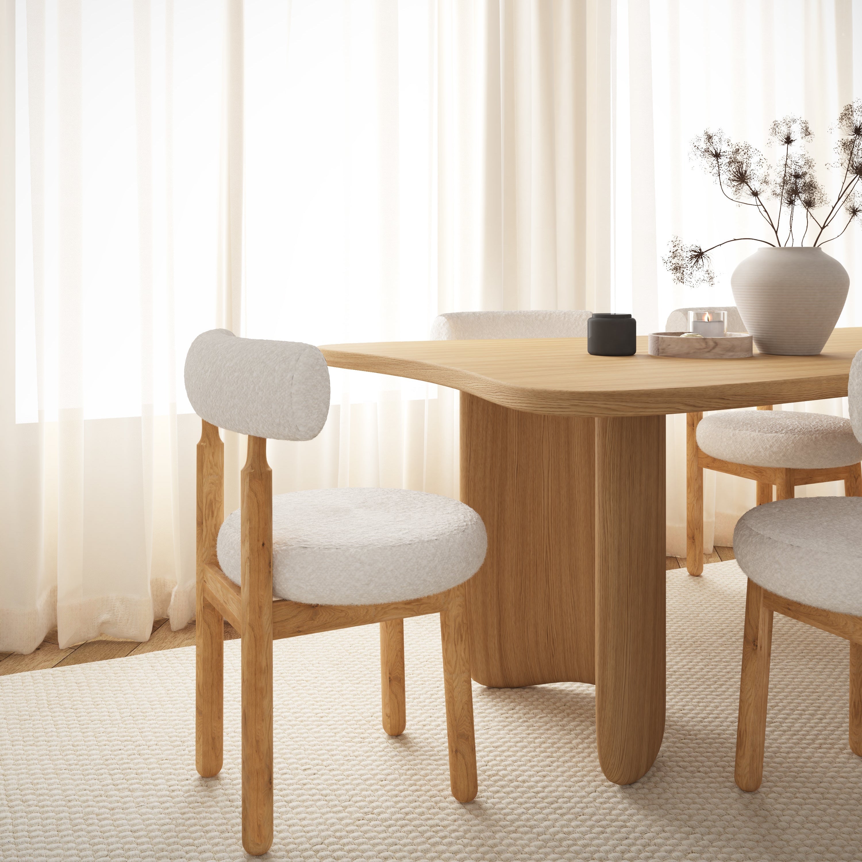 Dining room with wooden table and chairs in a bright room with white curtains.
