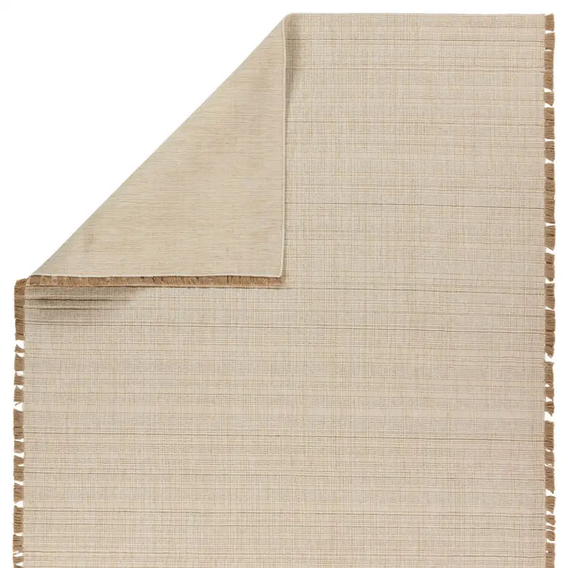 Beige woven mat with tassels on a white background