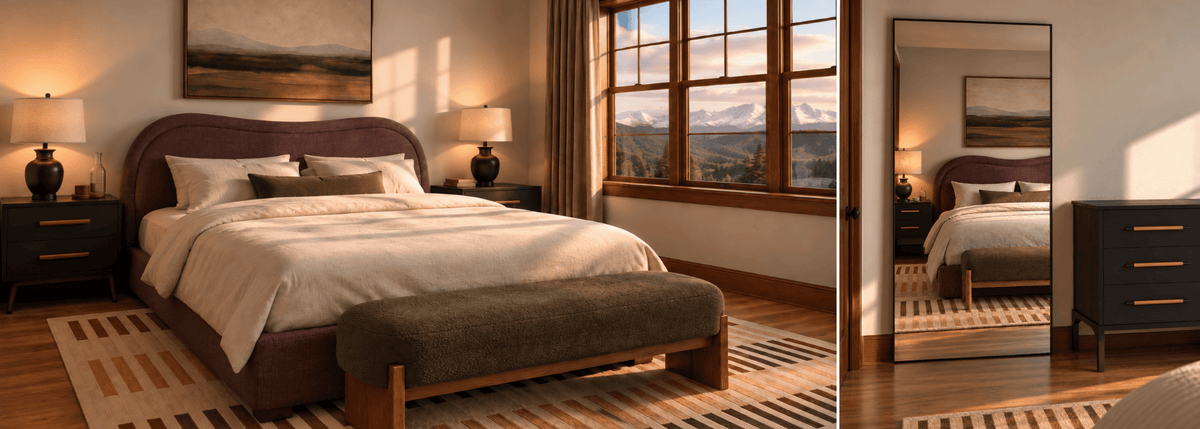 A styled bedroom interior showing a bed with cream bedding, a dark upholstered headboard and footboard, matching dark nightstands with lamps, a striped rug, and a large floor mirror reflecting the room. The scene is warm and sunlit with a window view of mountains in the background.