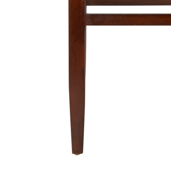 Close-up of a wooden chair leg on a white background