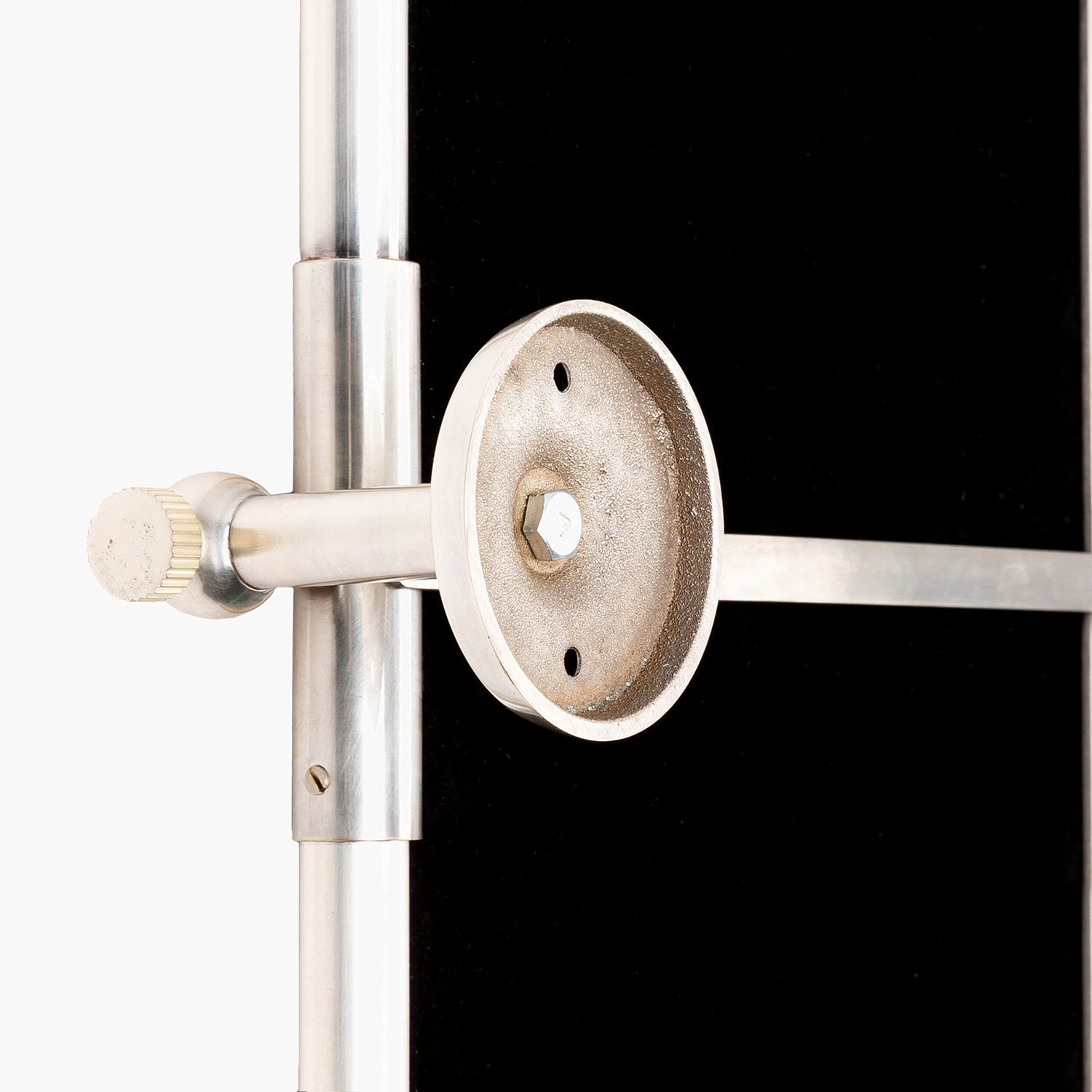 Metallic clamp or fixture on a black and white background