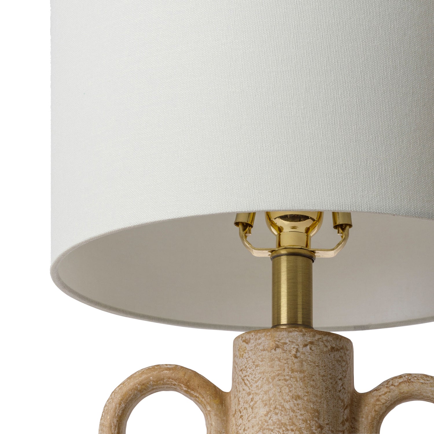 Table lamp with a beige ceramic base and gold accents on a white background