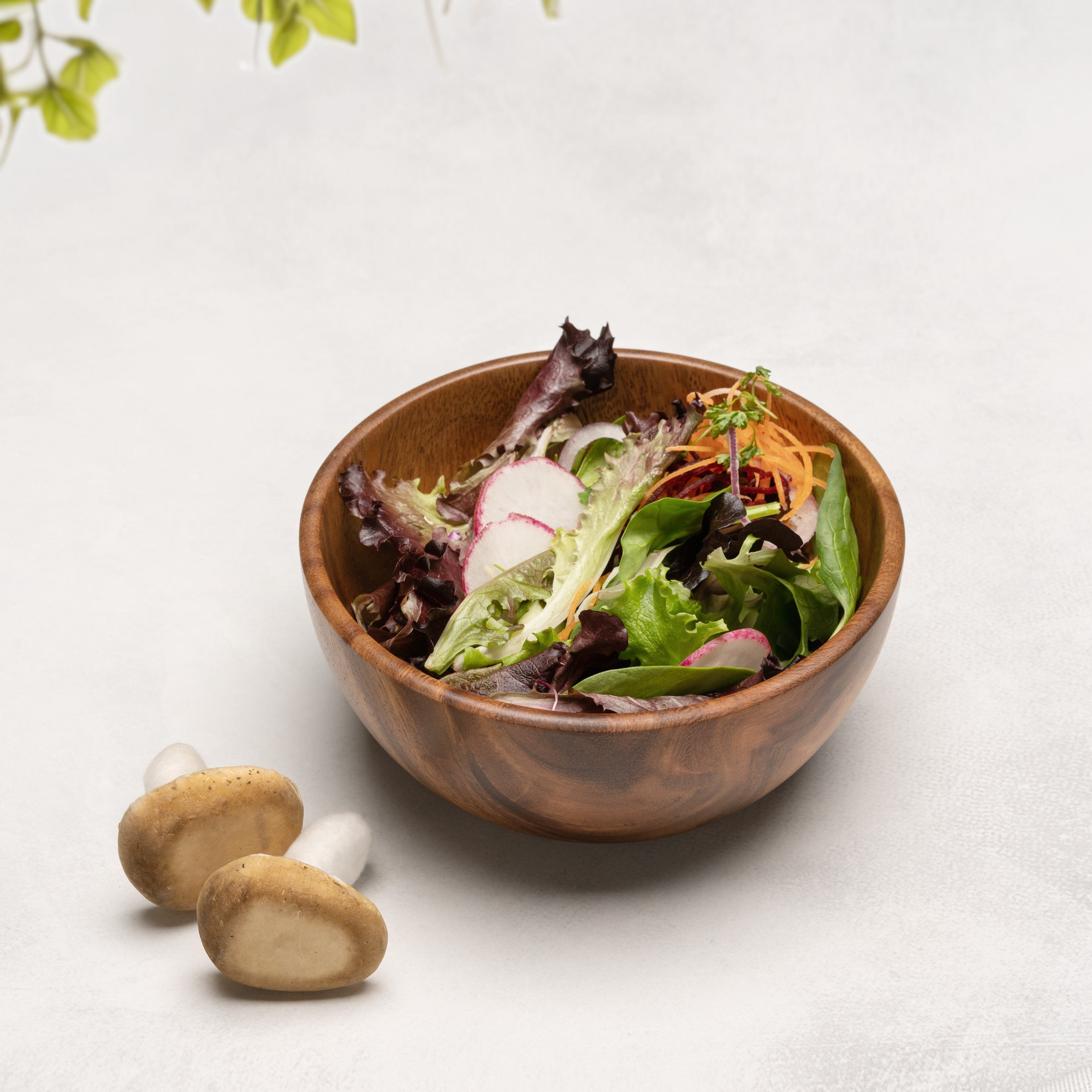 Salad in a wooden bowl on a grey surface