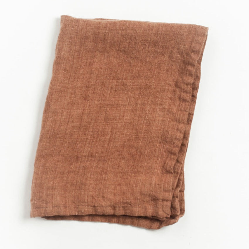 Terracotta linen kitchen towel on white background