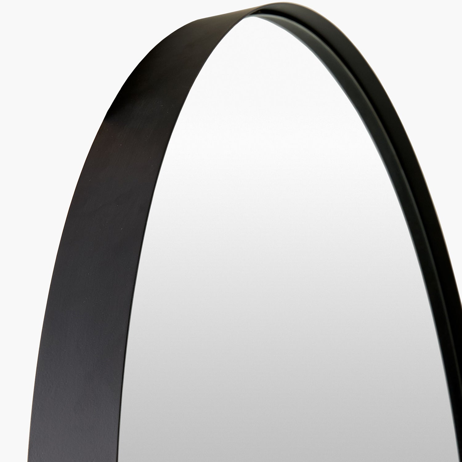 Round mirror with a black frame on a white background