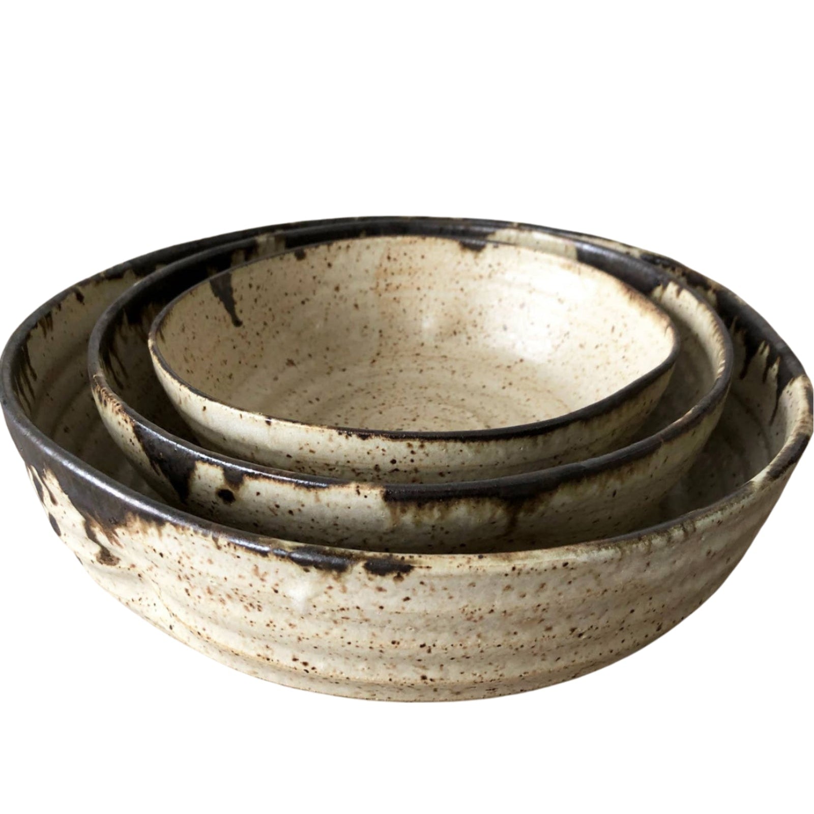 Set of three ceramic bowls with a speckled glaze on a white background