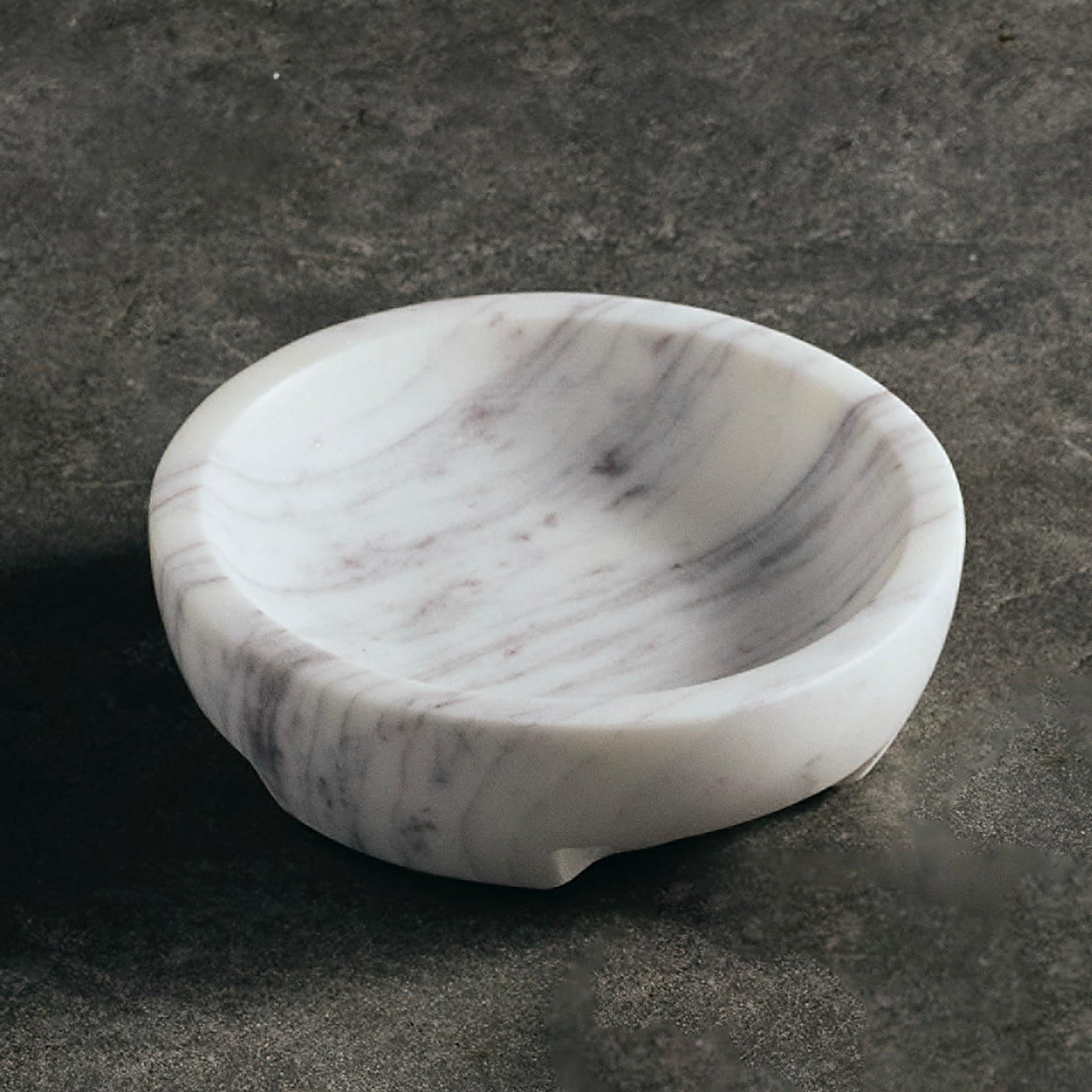 Marble-patterned stone bowl on a dark gray background
