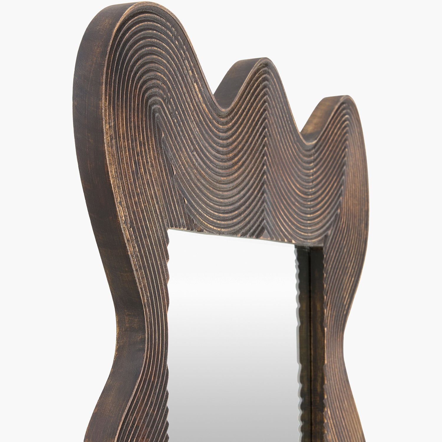 Decorative mirror with wavy, layered design on a white background