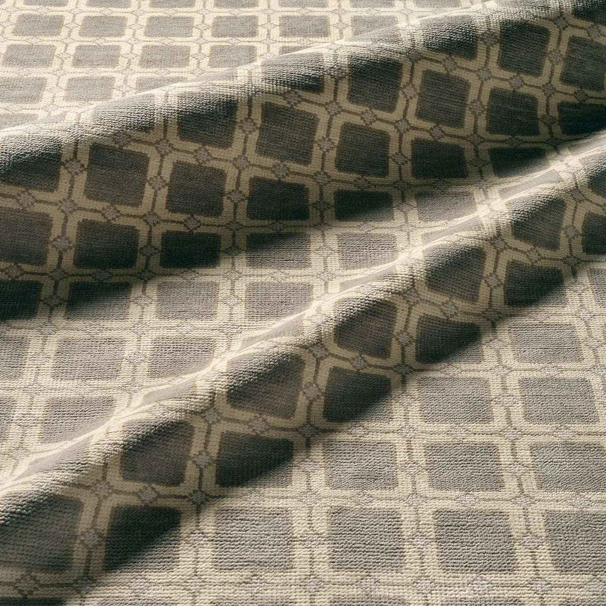 Textile fabric with a geometric pattern in shades of gray.