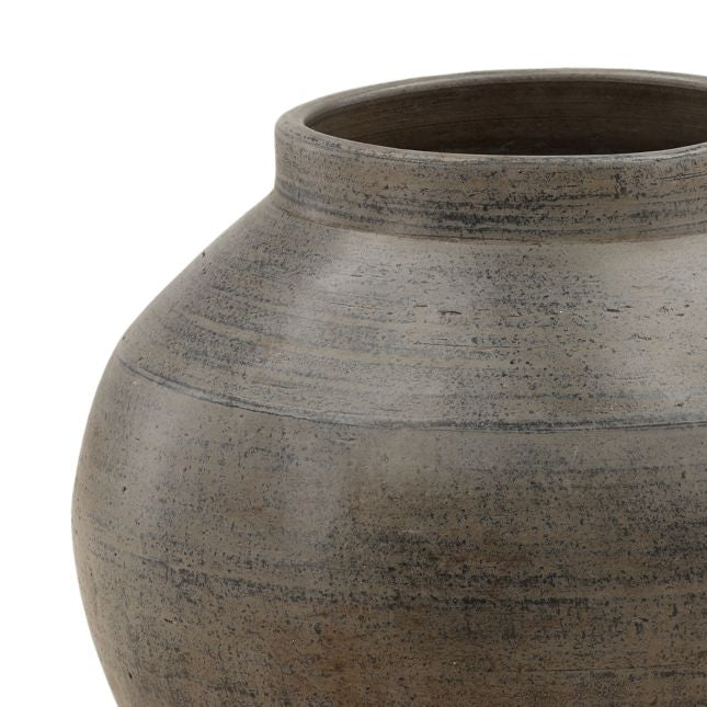 Close-up of a textured ceramic jar on a white background