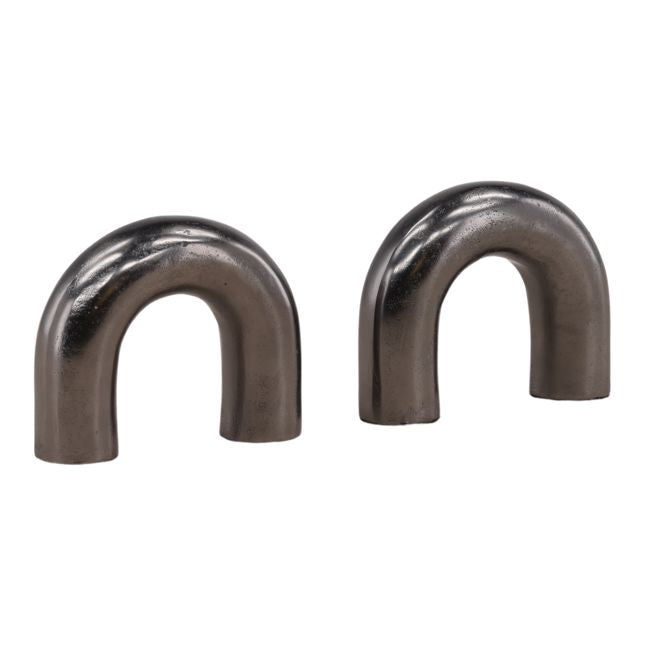 Two metallic U-shaped bookends on a white background
