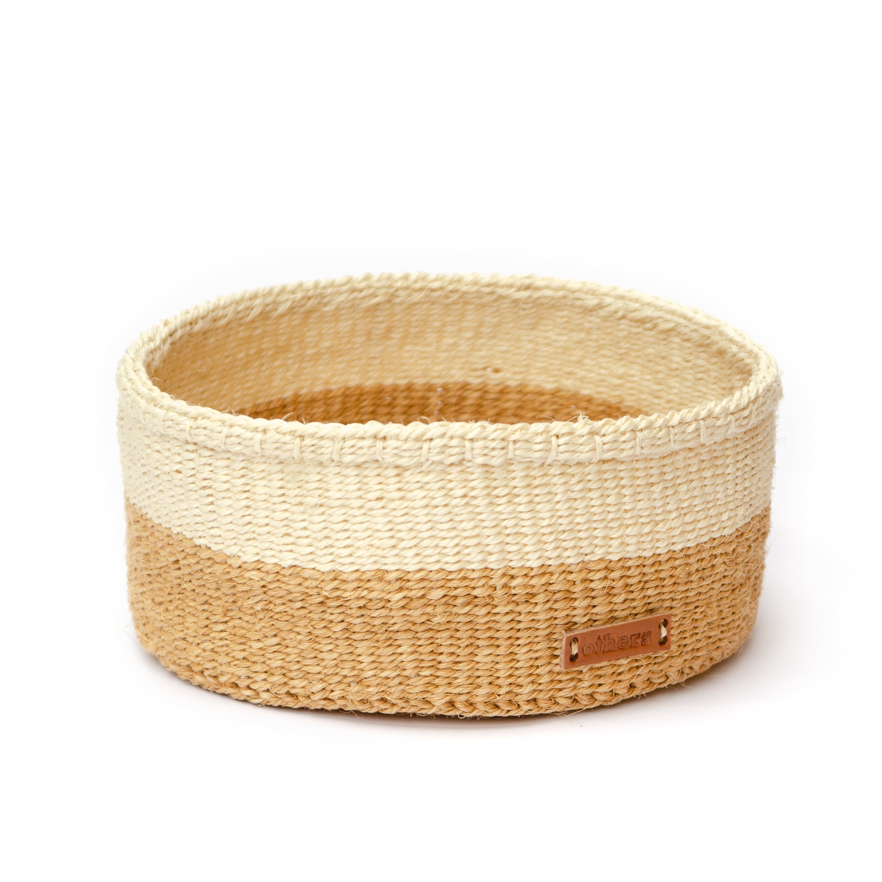 Woven basket with two-tone design on a white background