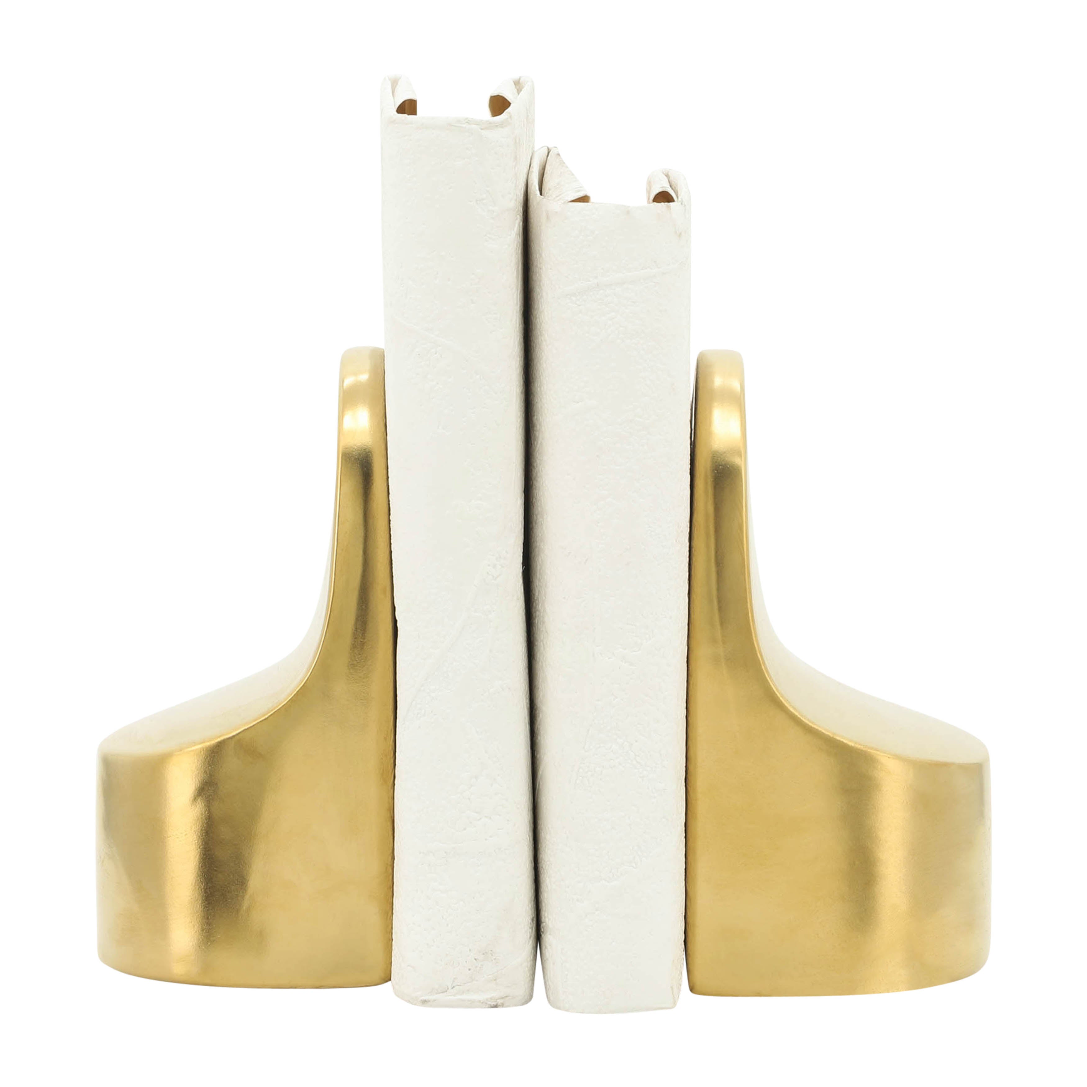 Gold bookends holding white books on a white background