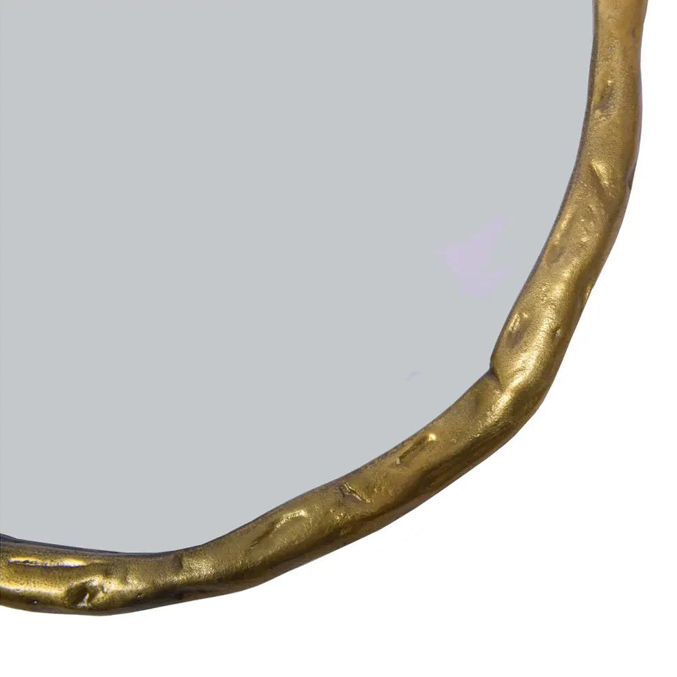 Round mirror with a gold frame on a white background