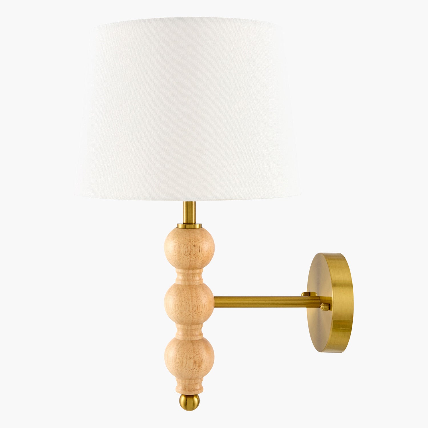 Wall-mounted lamp with wooden and brass design with a white shade on a white background