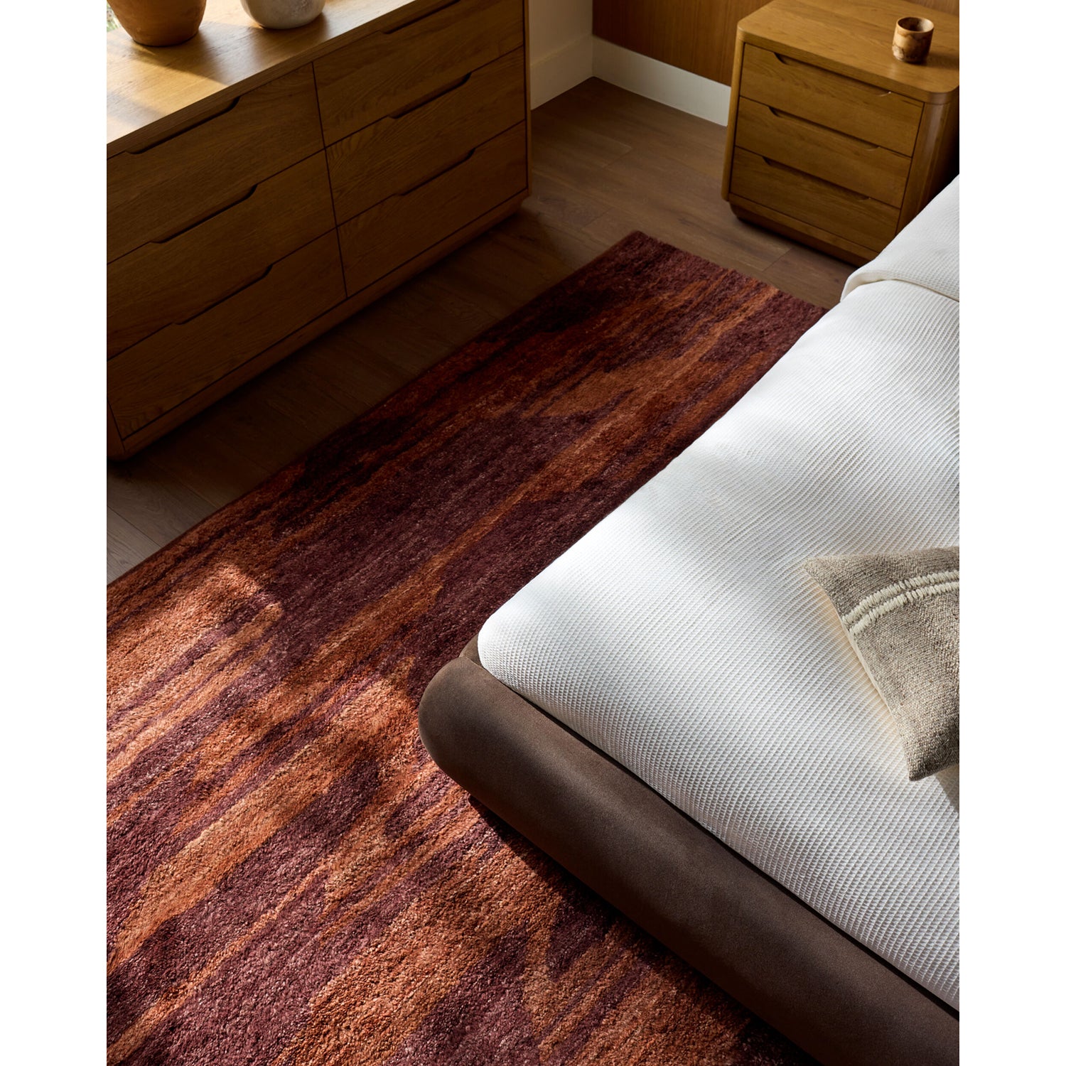 Bedroom with wooden dresser, nightstand, and rug