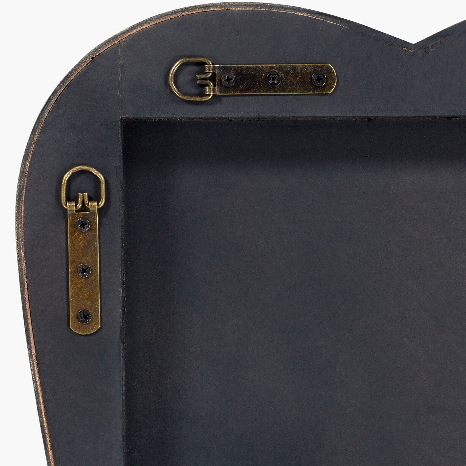 Black backing of mirror with gold brackets 