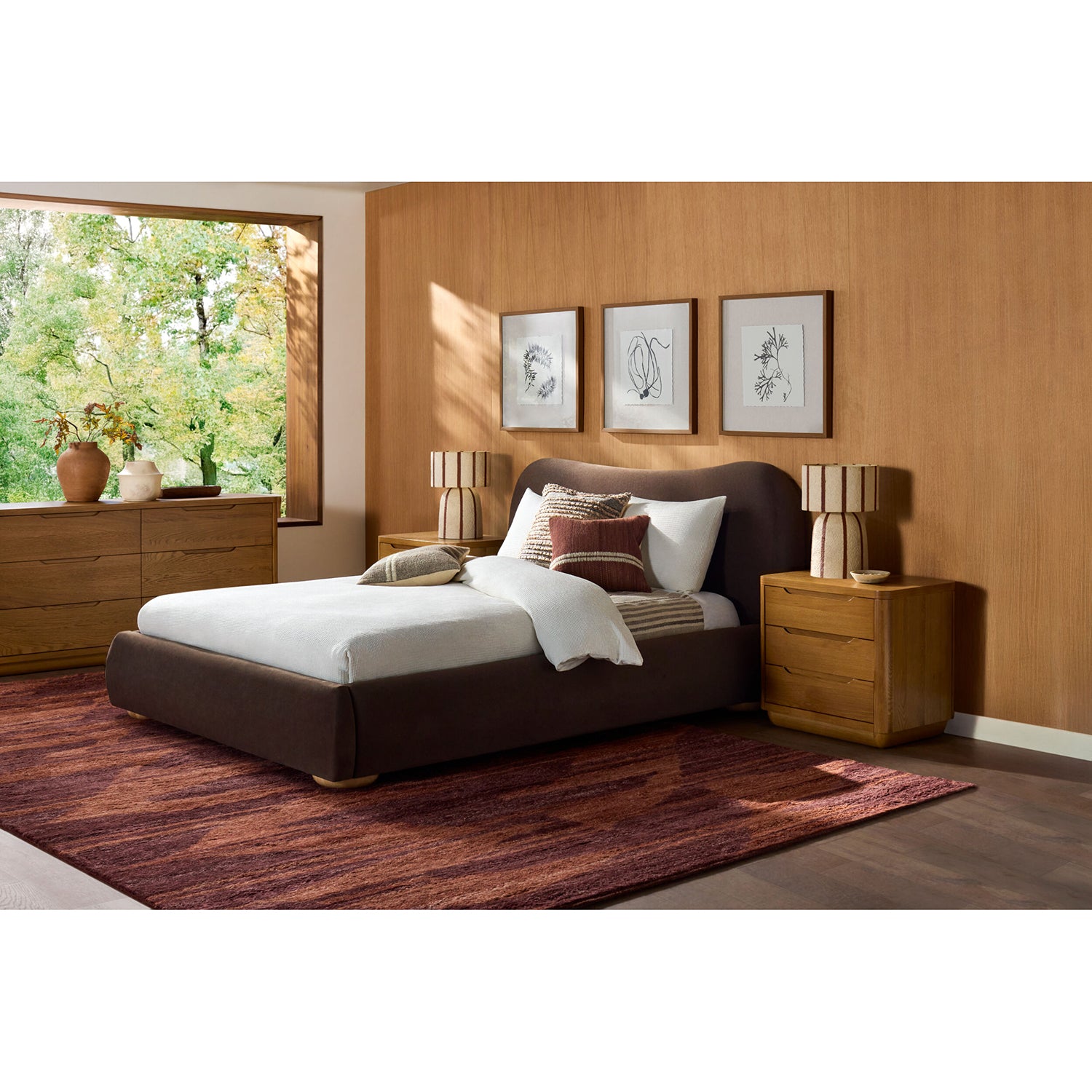 Modern bedroom with a bed, nightstands, and wall art.