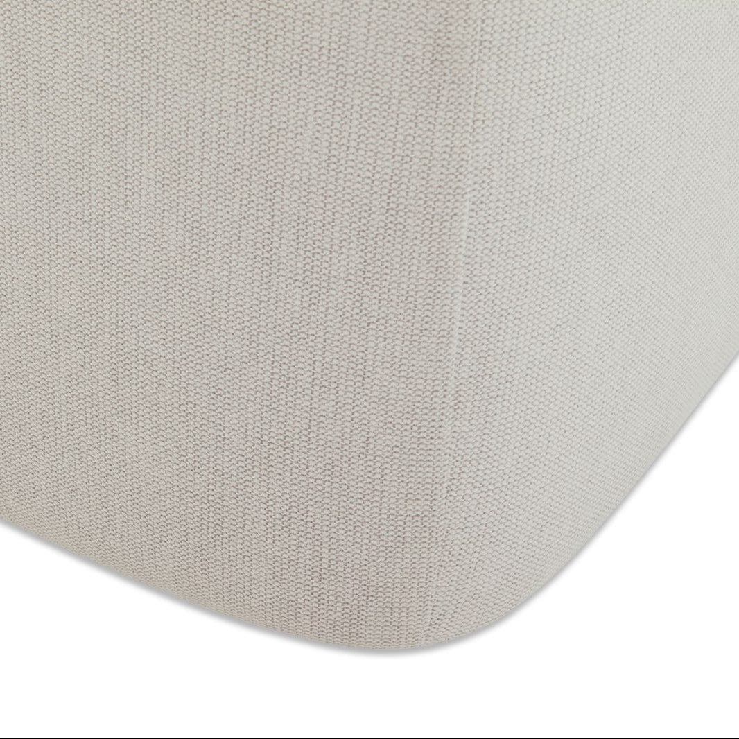 Close-up of a textured beige fabric surface on a white background