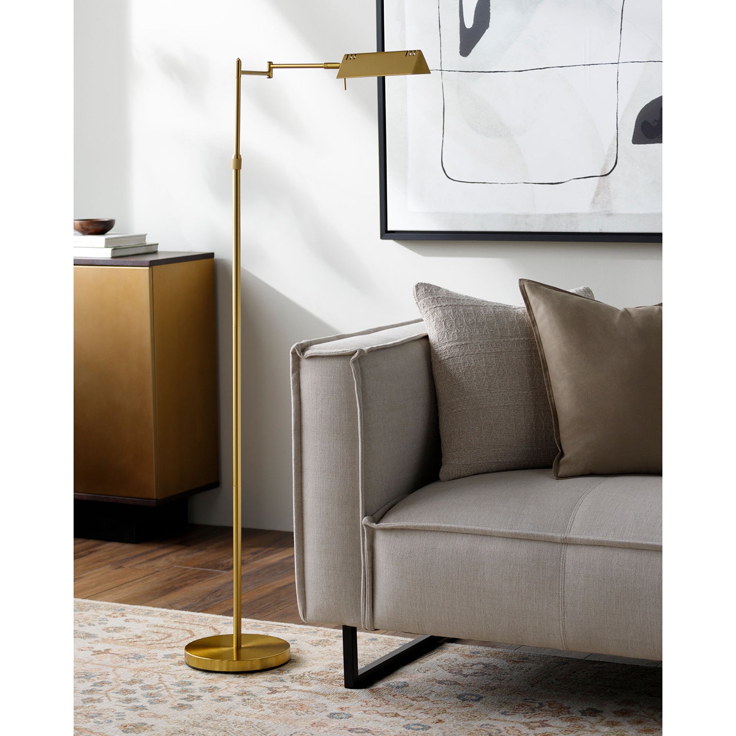 Gold floor lamp next to a gray sofa in a living room setting