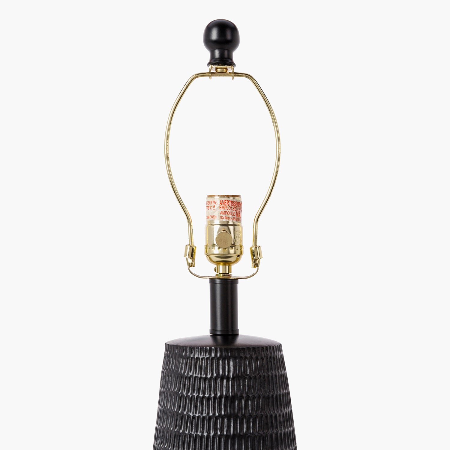 Decorative lamp with textured base and gold lampshade on a white background