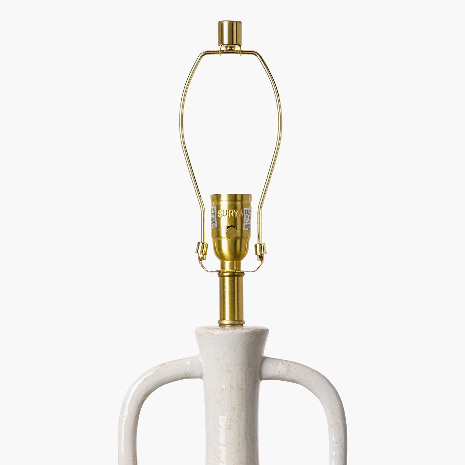 Lamp with white base and gold fitting on a white background