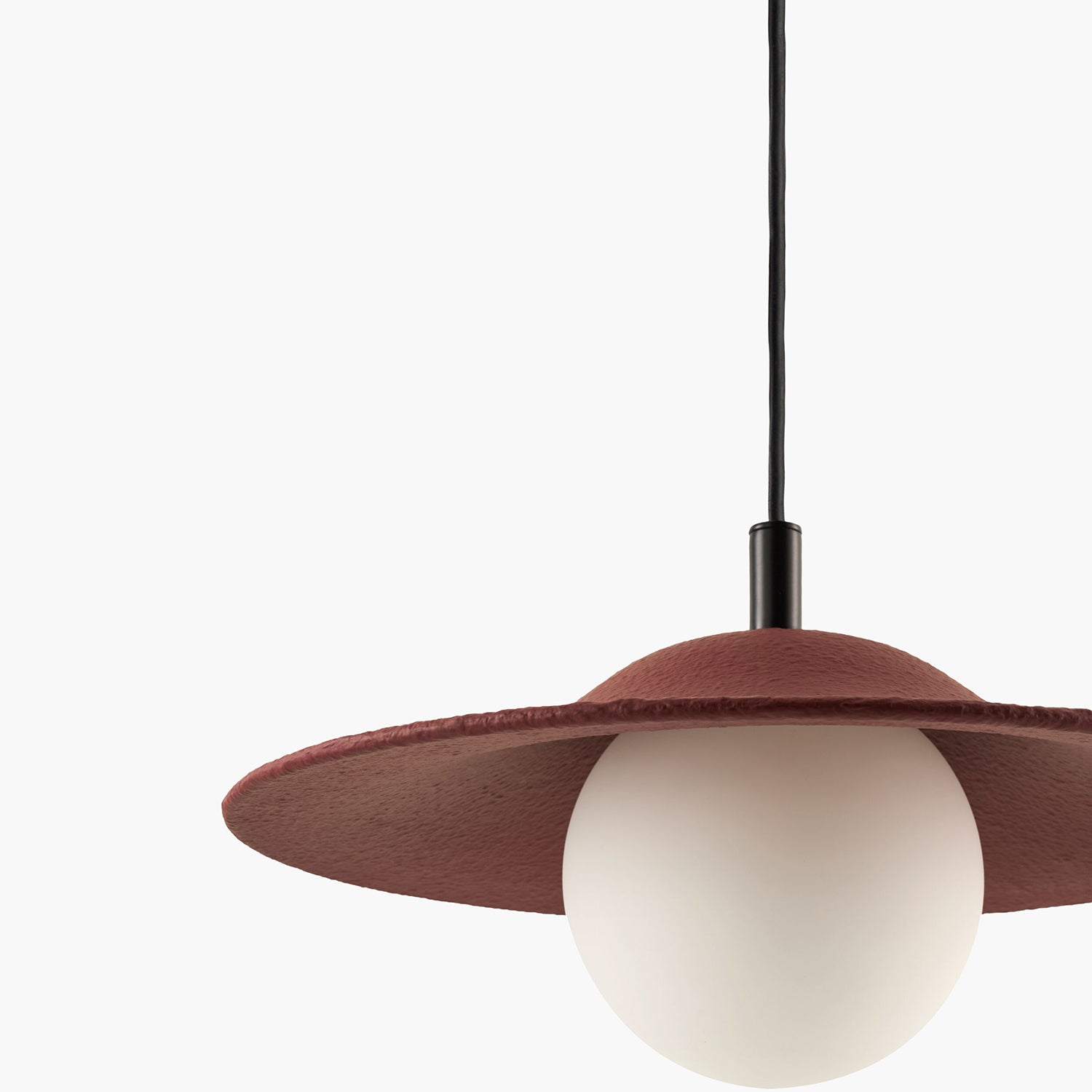 Pendant light with a brown shade and white bulb on a white background