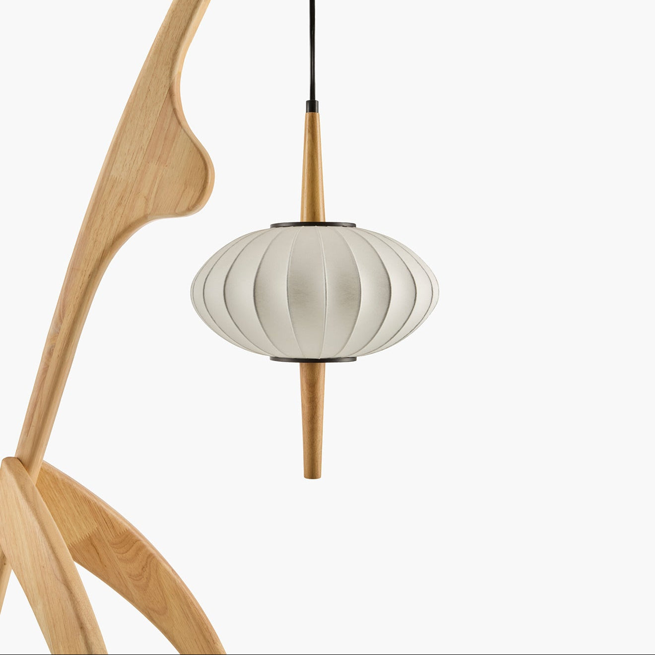 Modern pendant light with wooden fixture and white lampshade on a white background