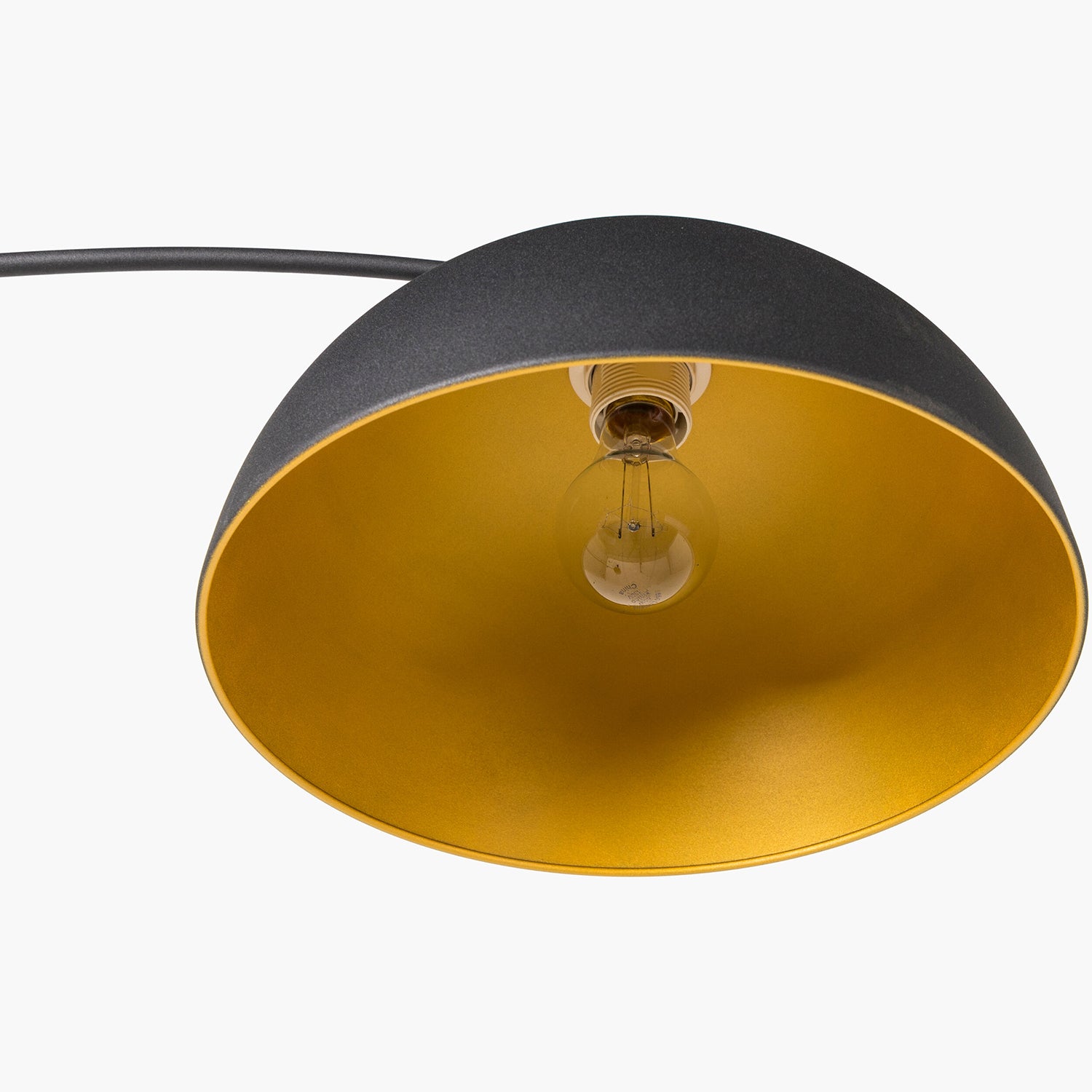 Lamp with black and gold shade on a white background