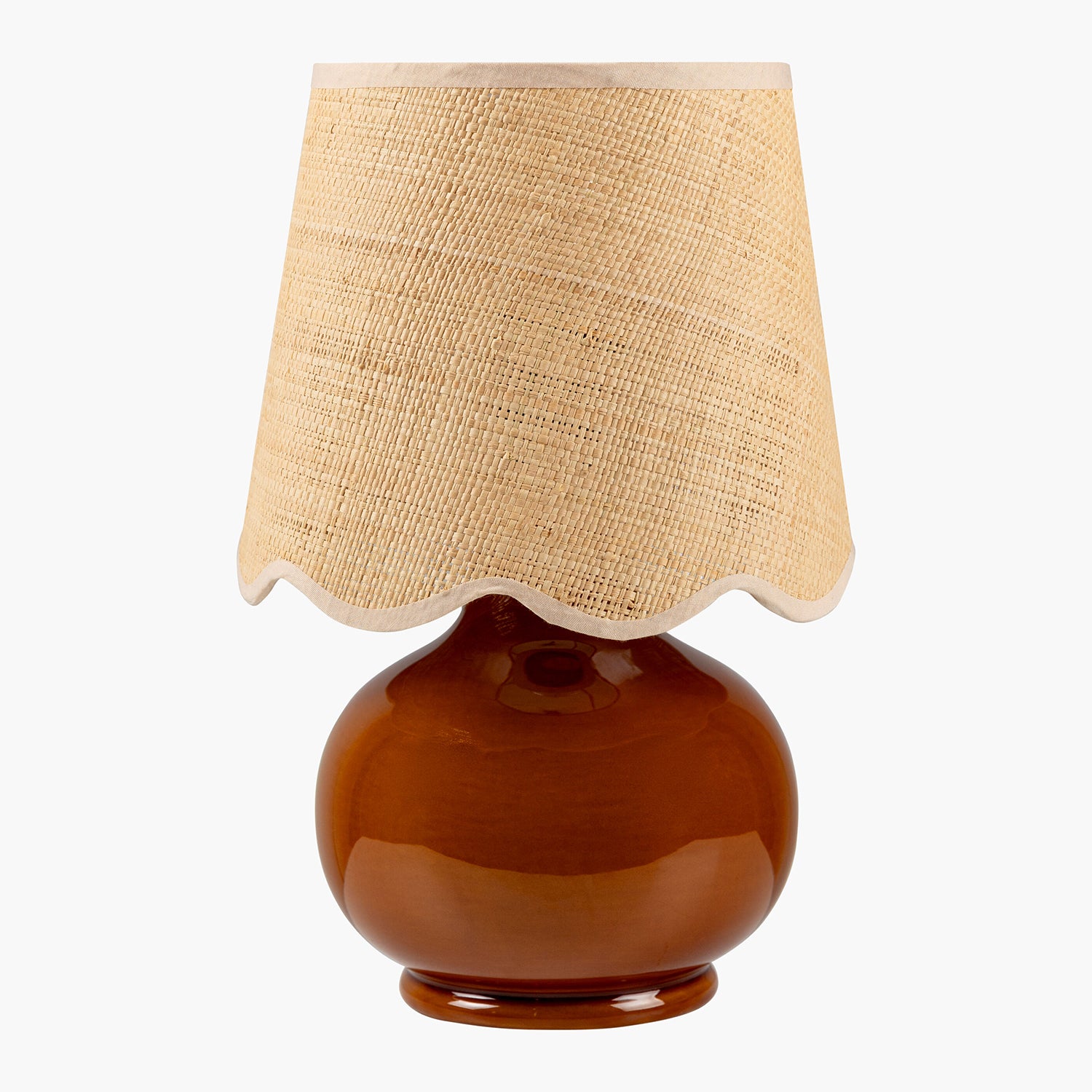 Table lamp with a brown base and beige fabric shade on a white background